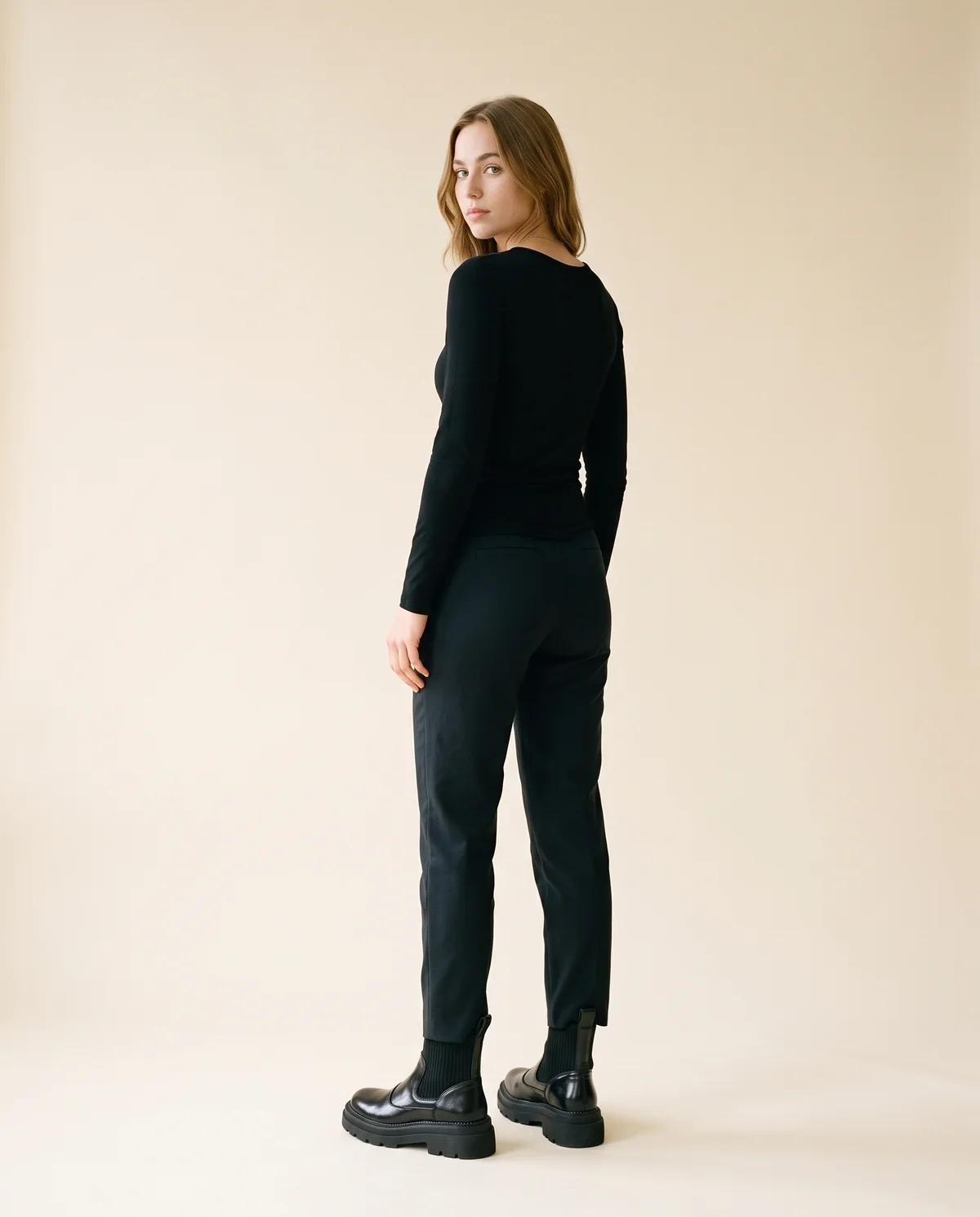 Chunky Platform Chelsea Boot in Black, back view, worn by Ava