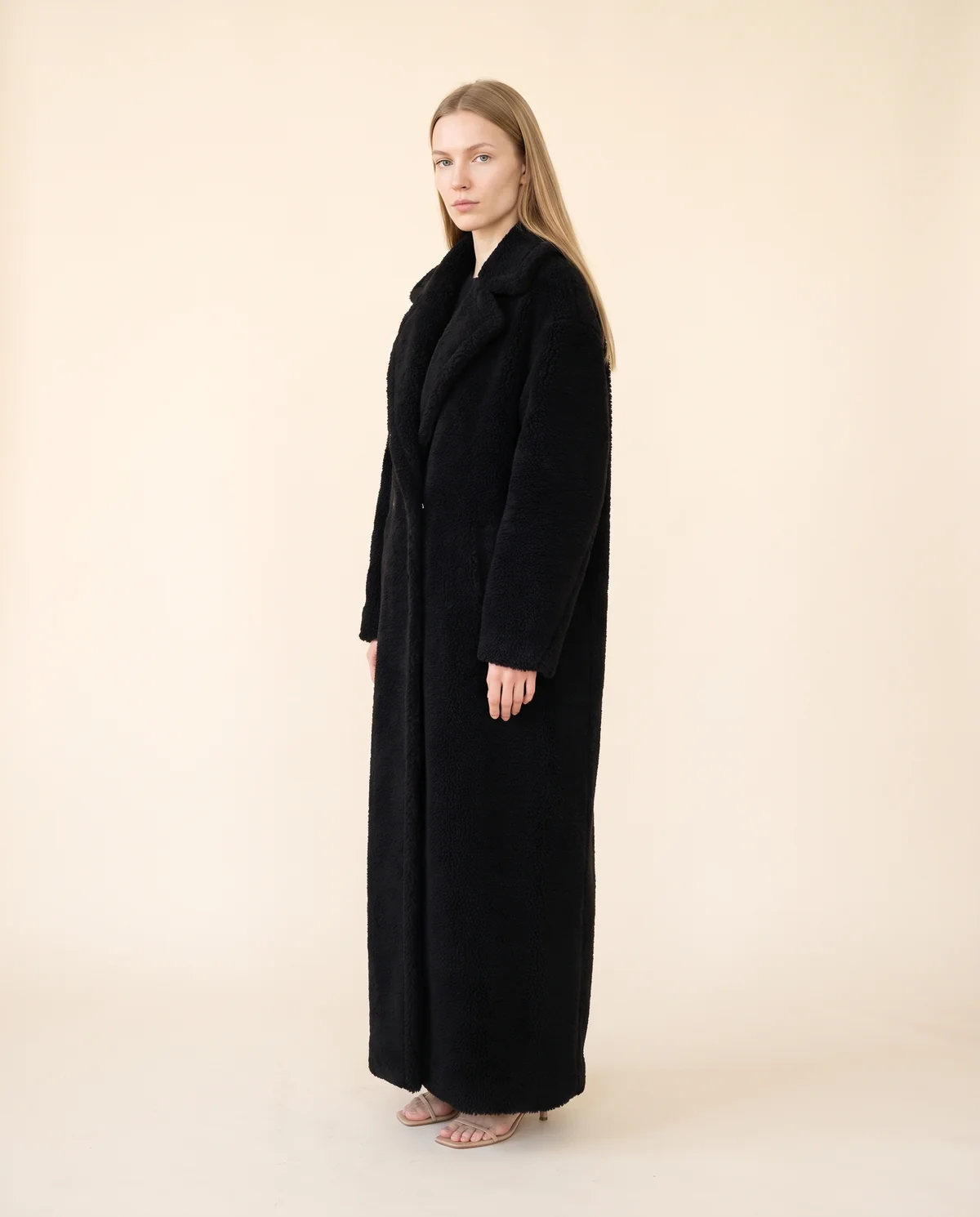 Maxi Teddy Coat in Black, side view, worn by Maya
