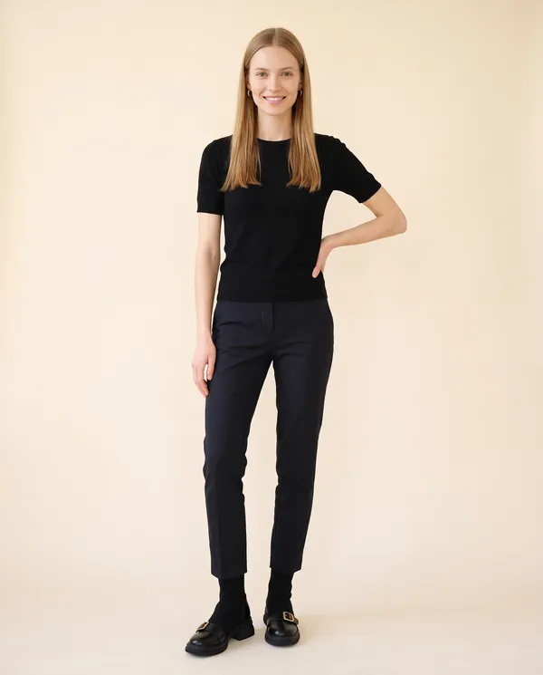Sock Ankle Boot with Buckle Toe-Cap in Black, front view, worn by Maya