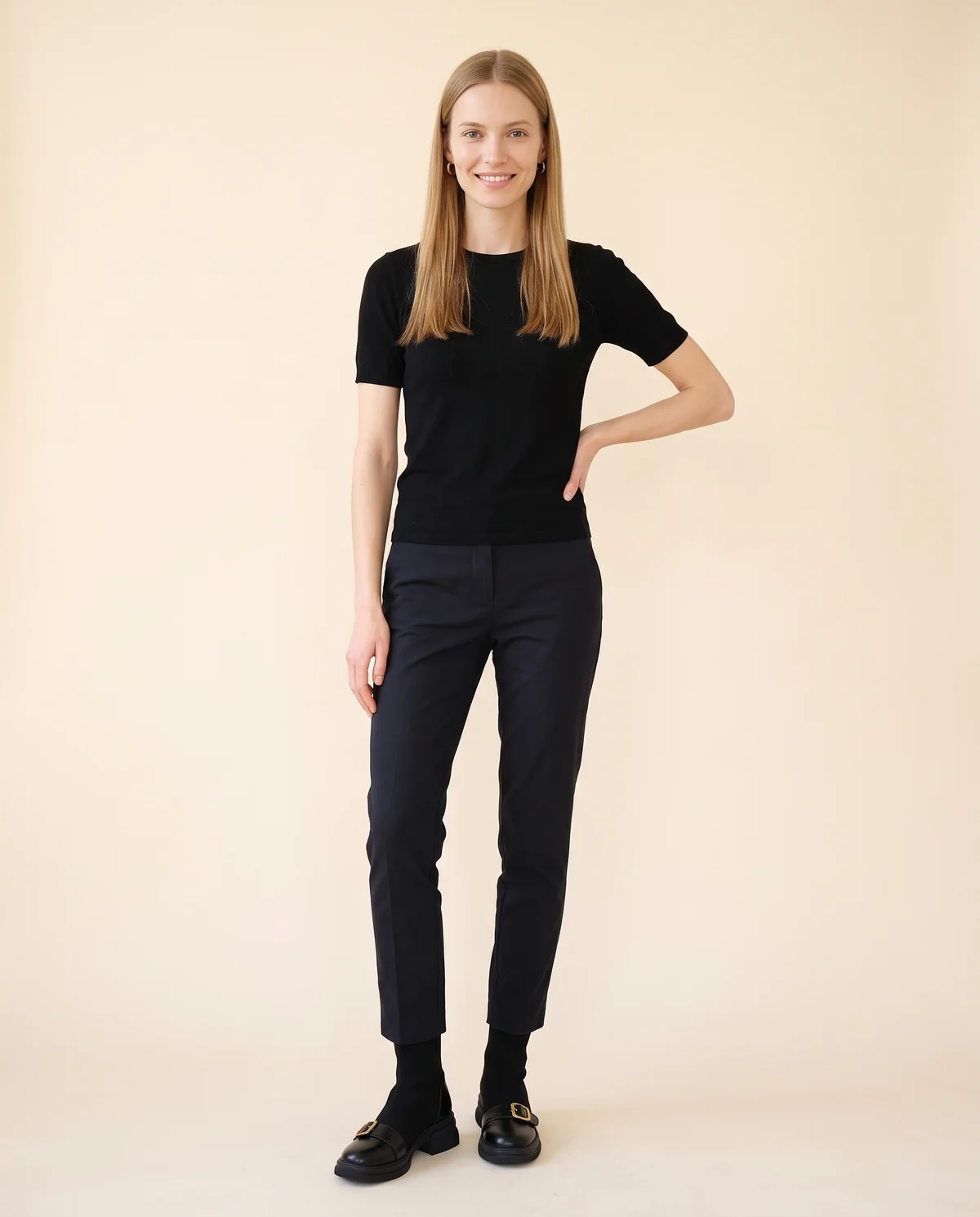 Sock Ankle Boot with Buckle Toe-Cap in Black, front view, worn by Maya