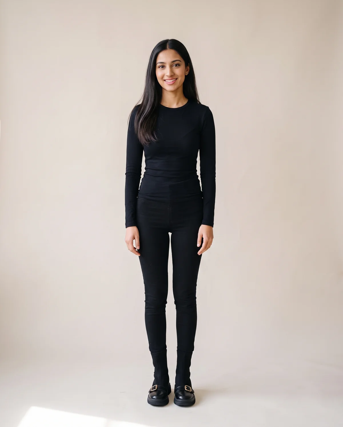Sock Ankle Boot with Buckle Toe-Cap in Black, front view, worn by Priya