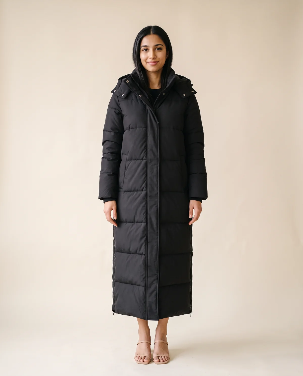 Maxi Puffer Coat with Side Zips in Black, front view, worn by Priya