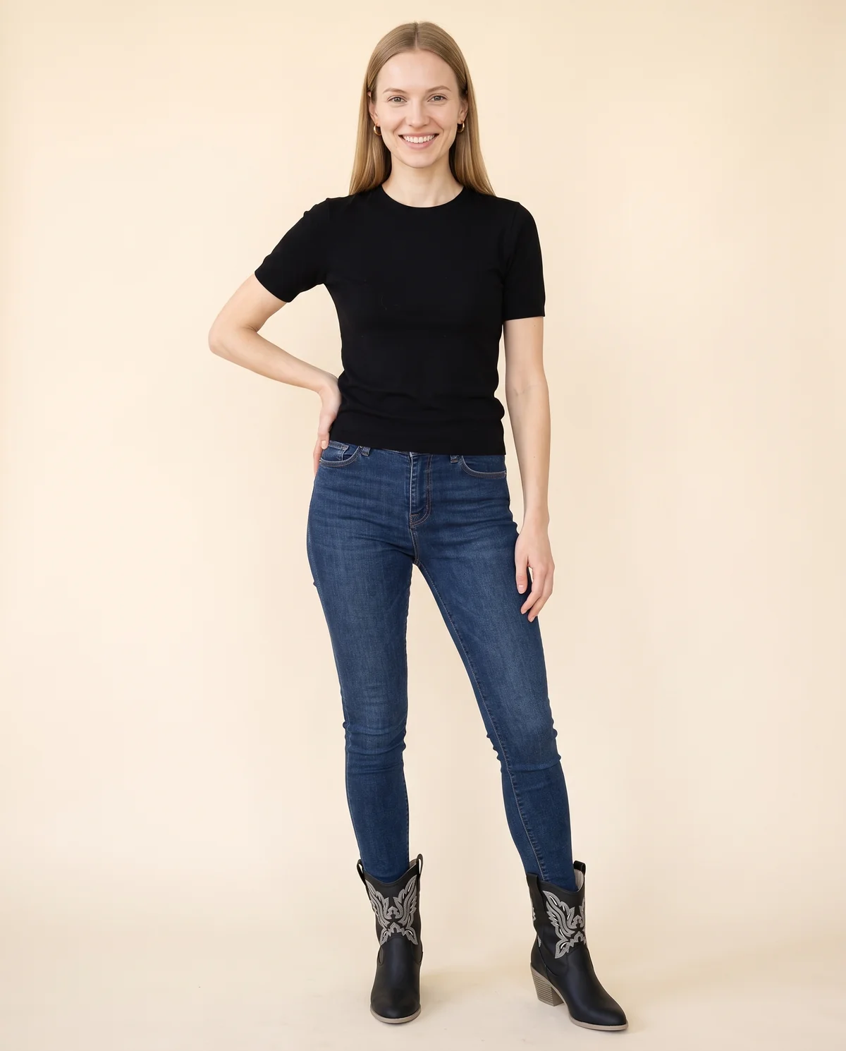 Black Embroidered Western Ankle Boot in Black, front view, worn by Maya