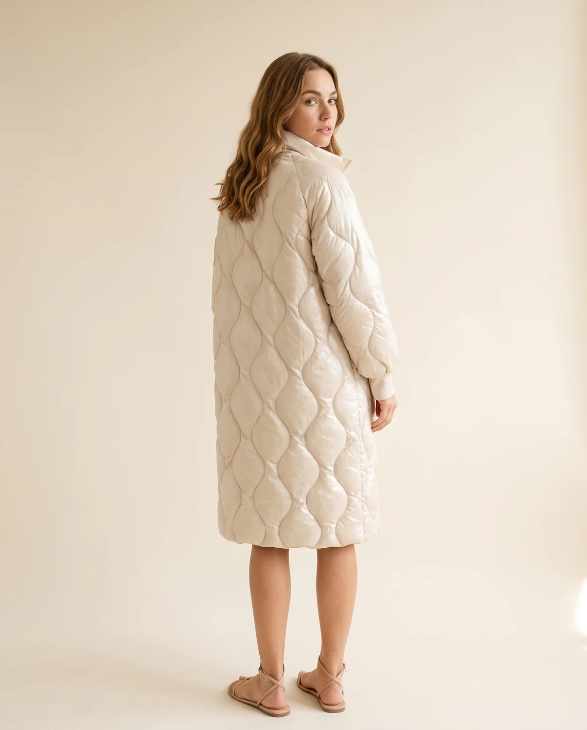 Glossy Quilted Puffer Coat in Cream, back view, worn by Ava
