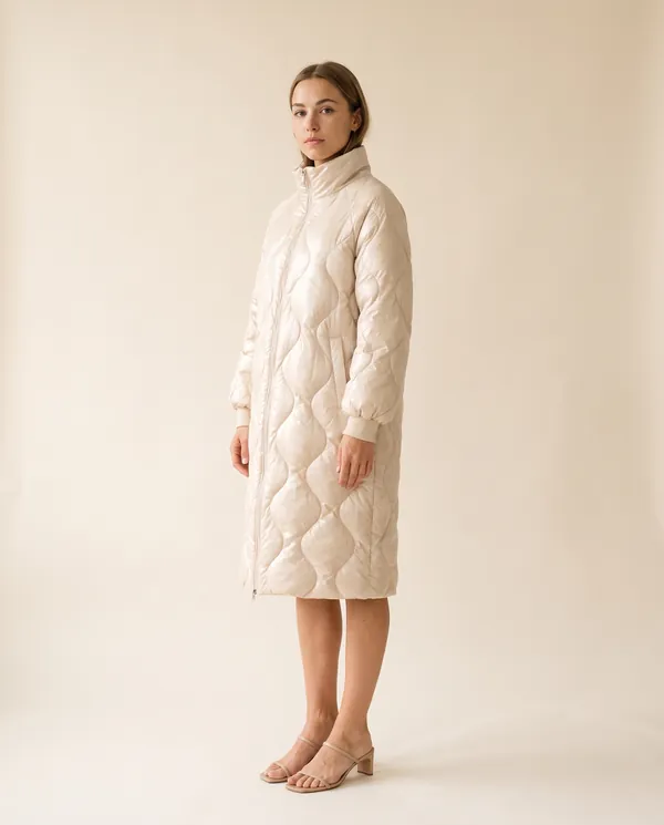 Glossy Quilted Puffer Coat in Cream, side view, worn by Ava