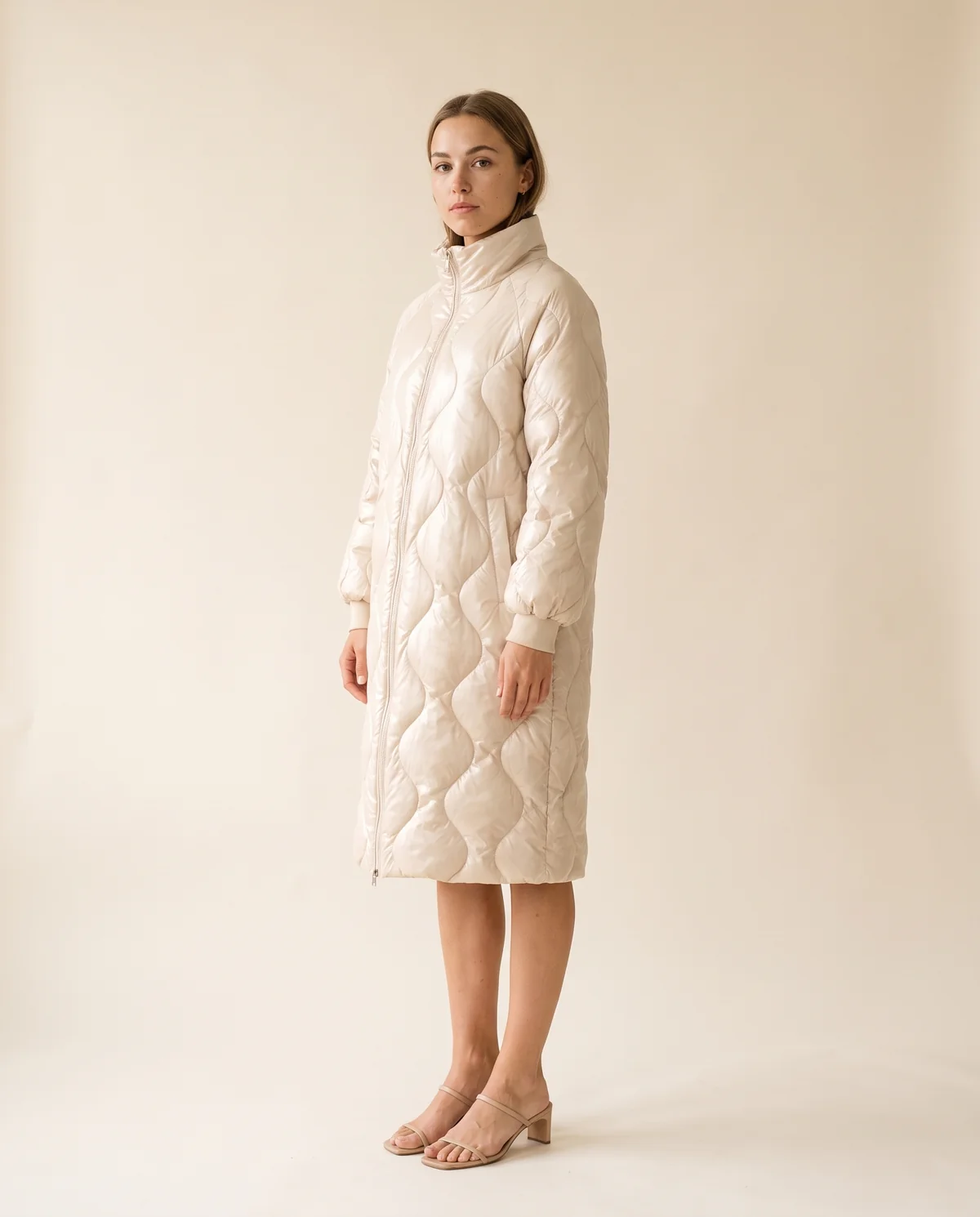 Glossy Quilted Puffer Coat in Cream, side view, worn by Ava