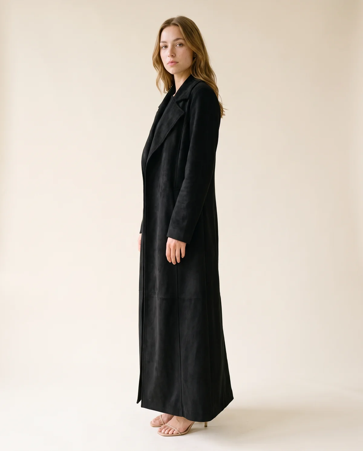 Long Faux Suede Coat in Black, side view, worn by Ava