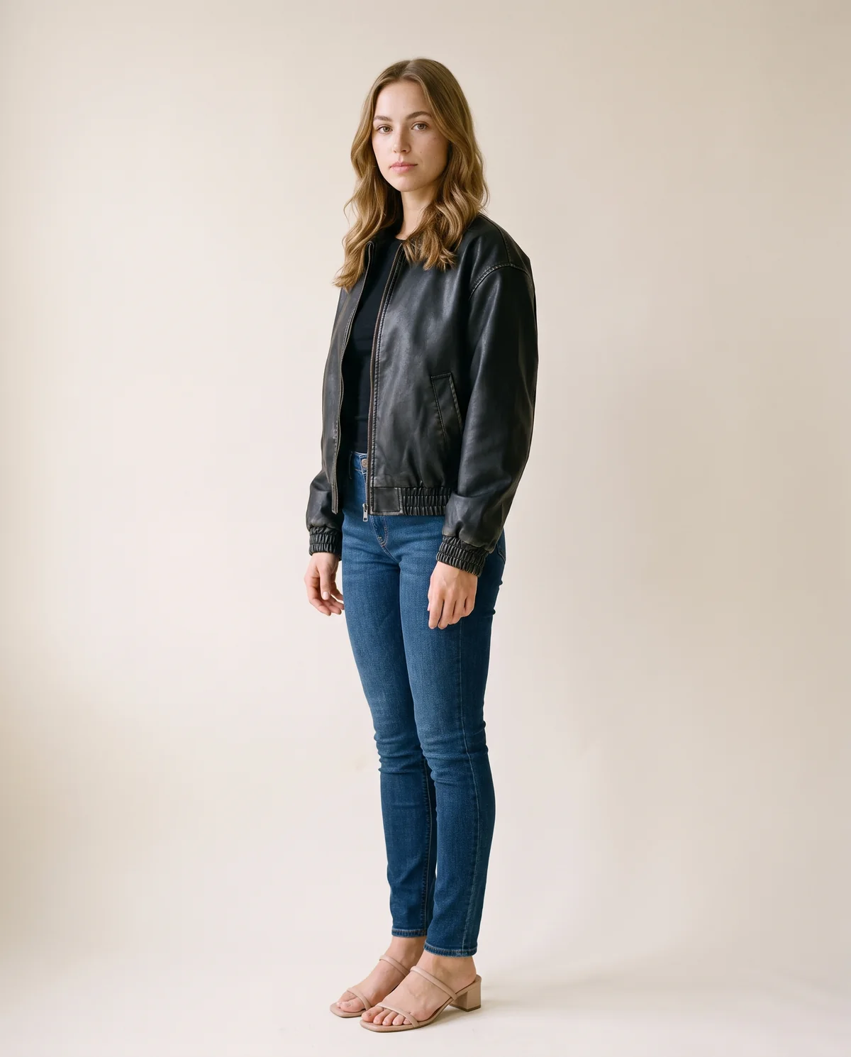 Faux Leather Aged-Finish Zip Bomber Jacket in Black, side view, worn by Ava