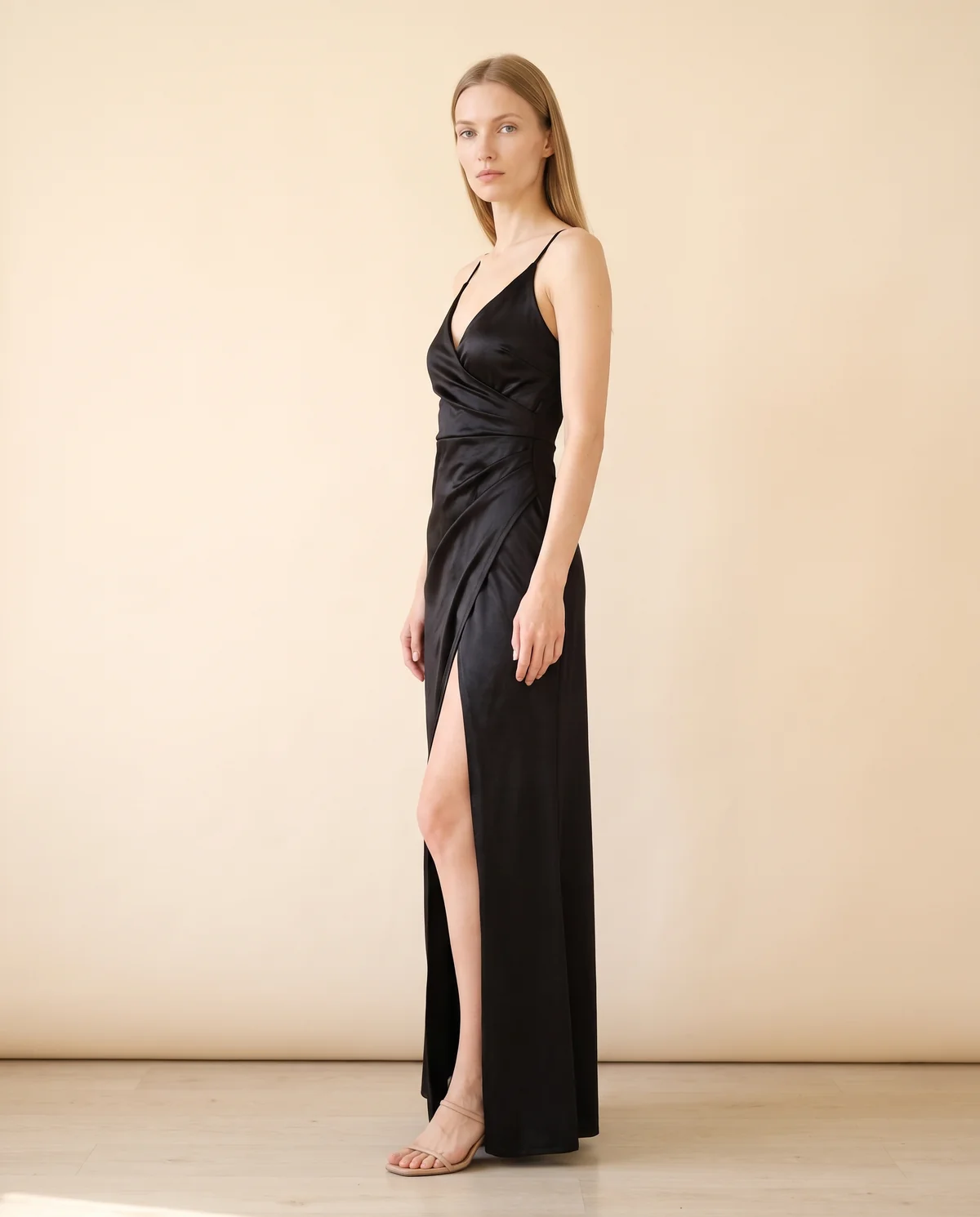 Stretch Satin Wrap Maxi Dress in Black, side view, worn by Maya