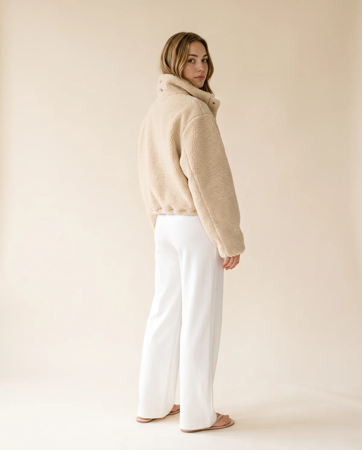 Faux Teddy Cropped Stand-Collar Jacket in Cream, back view, worn by Ava
