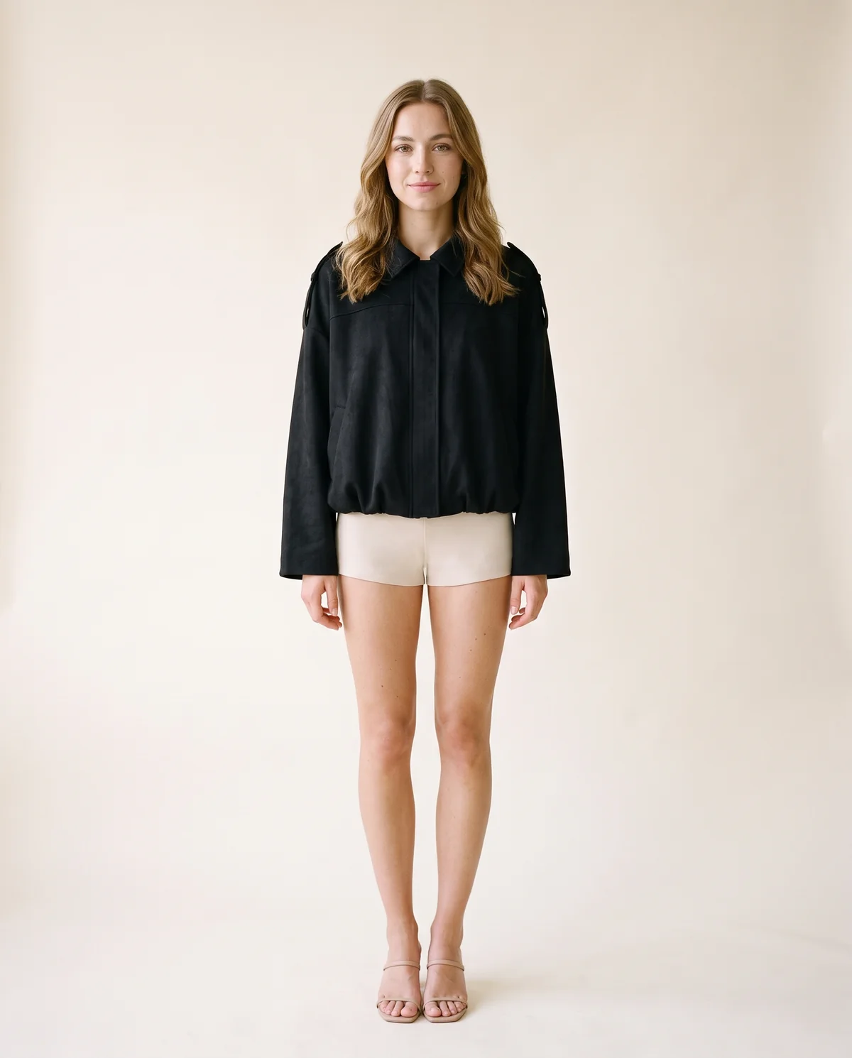 Faux Suede Bubble-Hem Bomber Jacket in Black, front view, worn by Ava