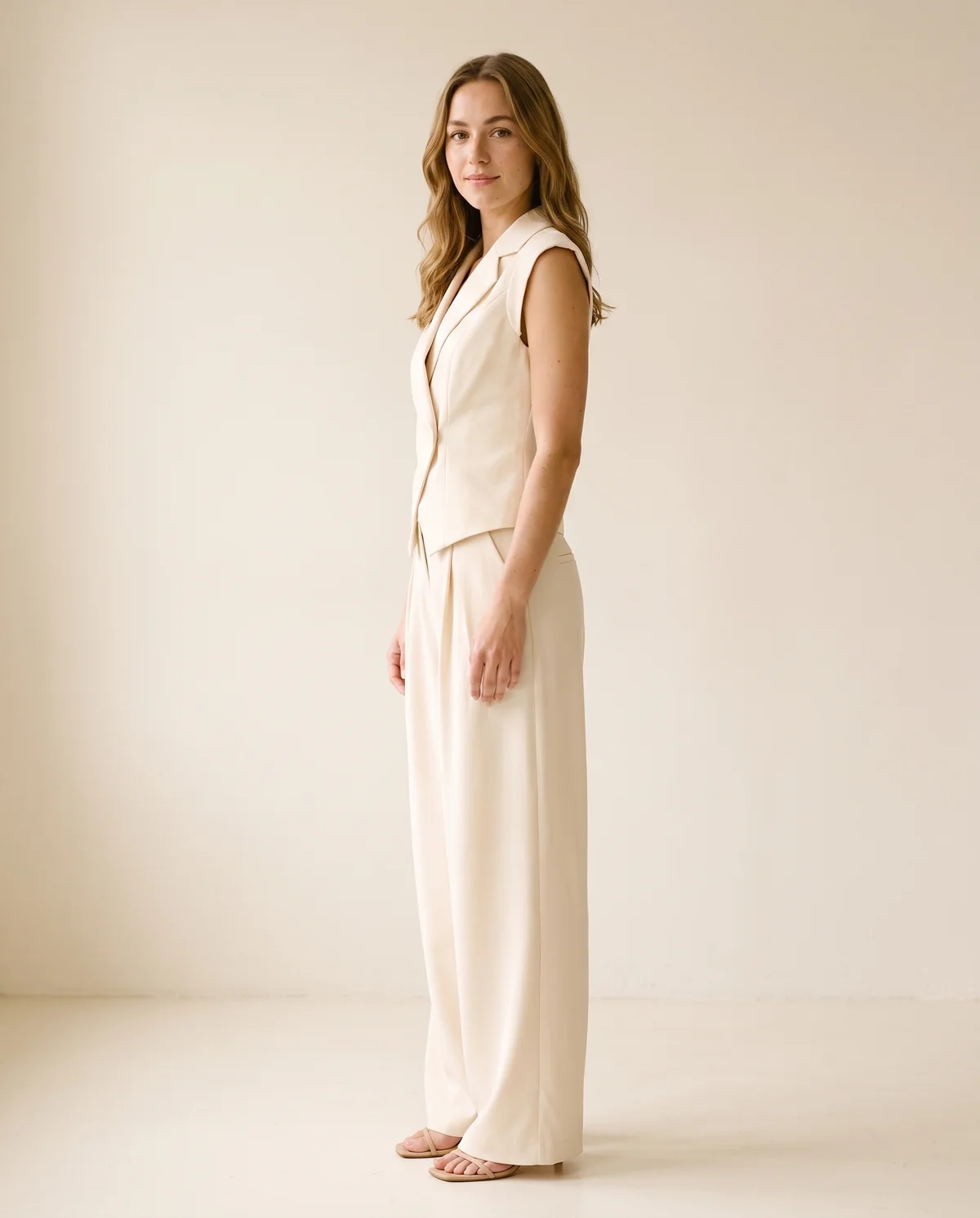 Sleeveless Waistcoat and Wide-Leg Trouser Set in Cream, side view, worn by Ava