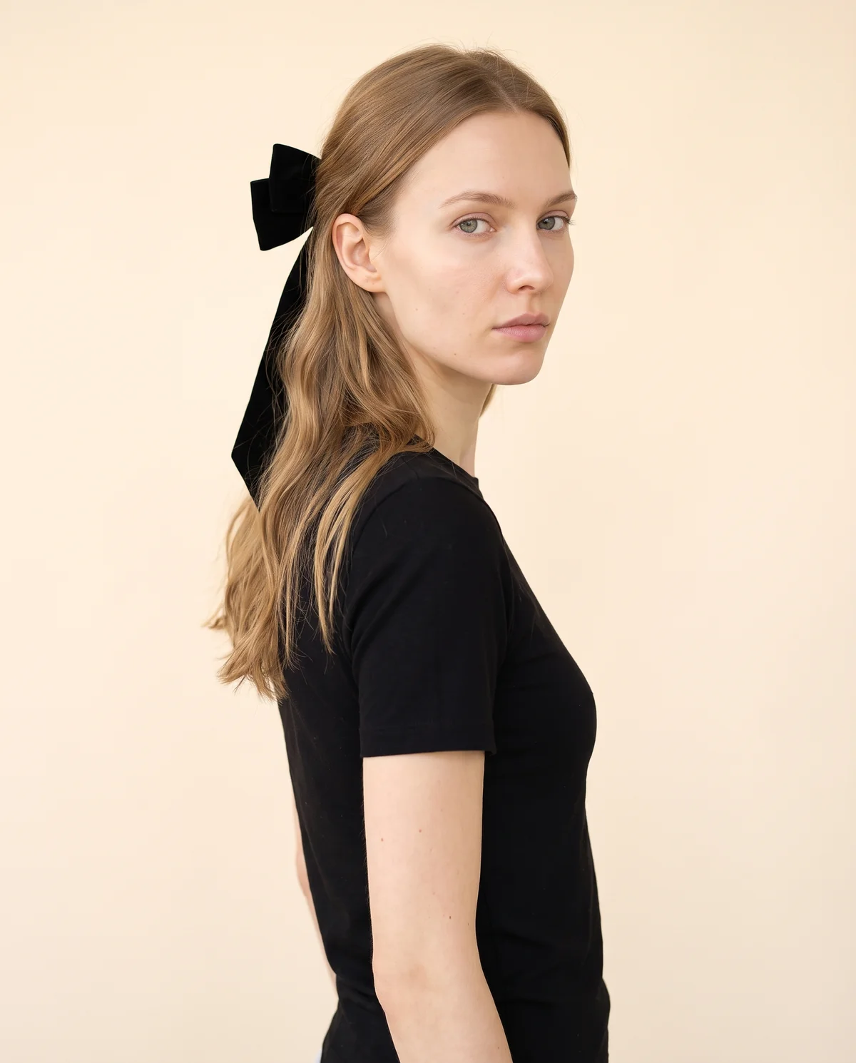 Velvet Bow Hair Barrette in Black, side view, worn by Maya