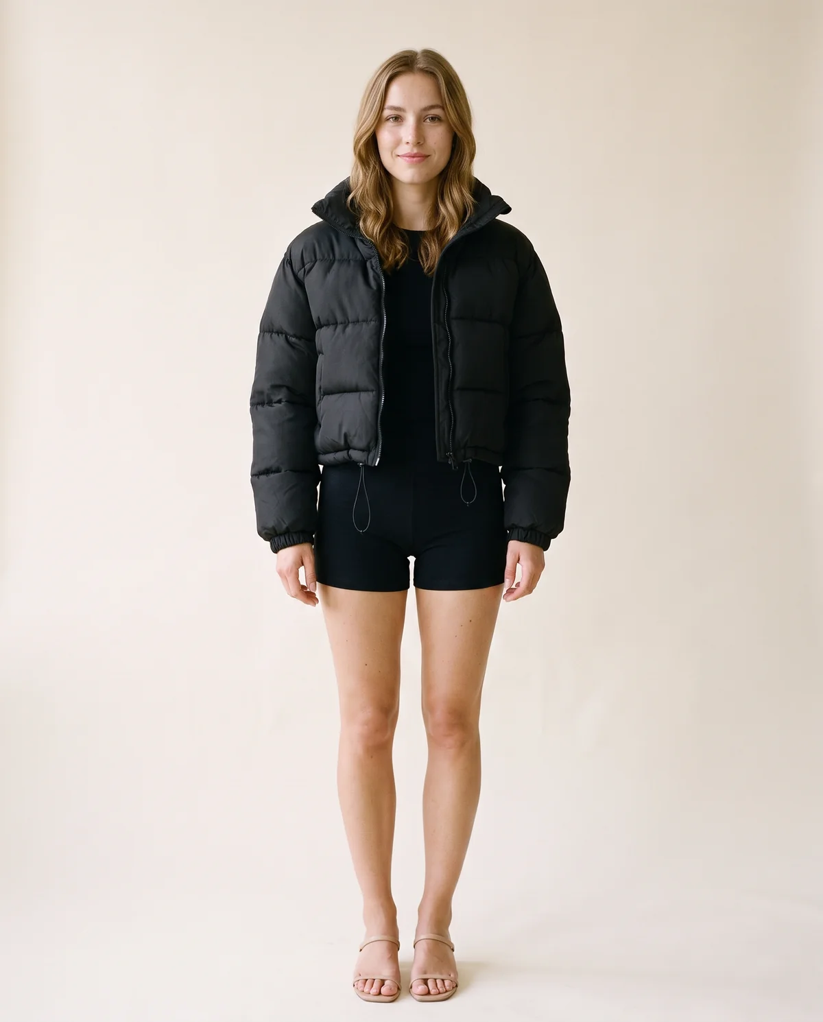 Cropped Puffer Jacket with Drawcord Hem in Black, front view, worn by Ava