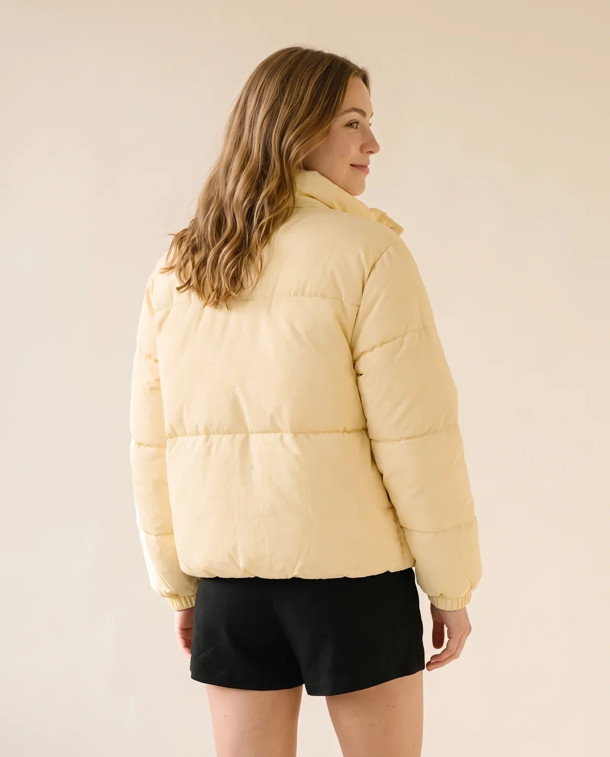 Short Stand-Collar Puffer with Snap Front in Yellow, back view, worn by Ava