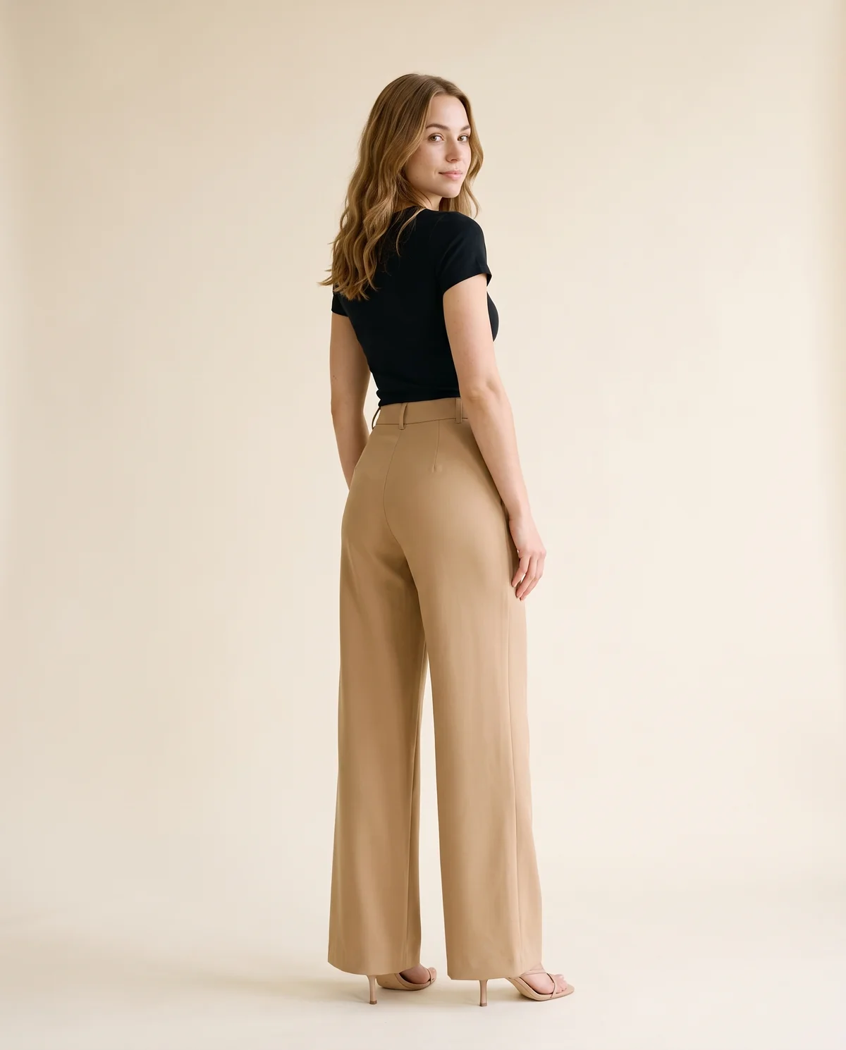 High-Waist Flared Tailored Trousers in Camel, back view, worn by Ava