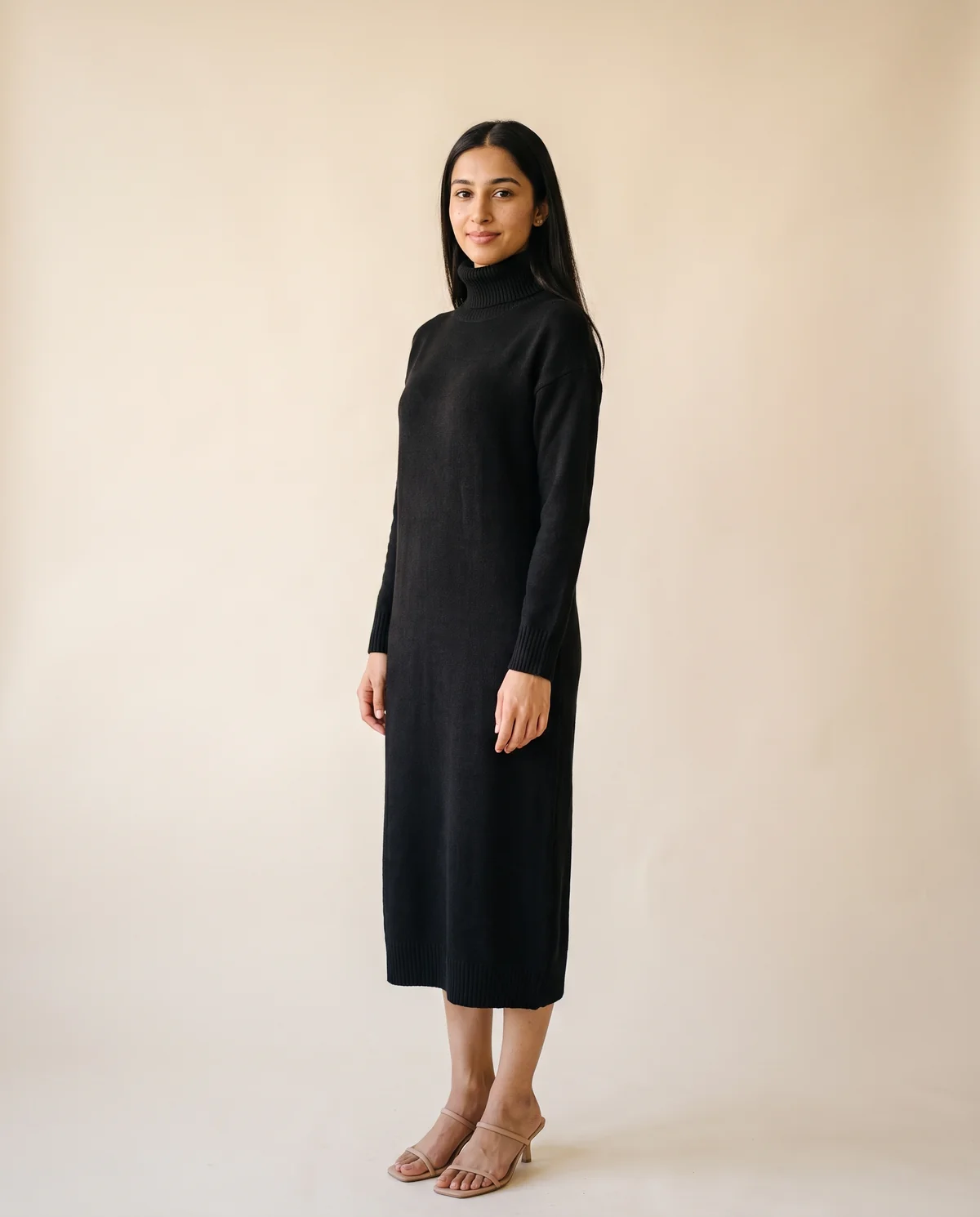 Turtleneck Knit Midi Dress in Black, side view, worn by Priya