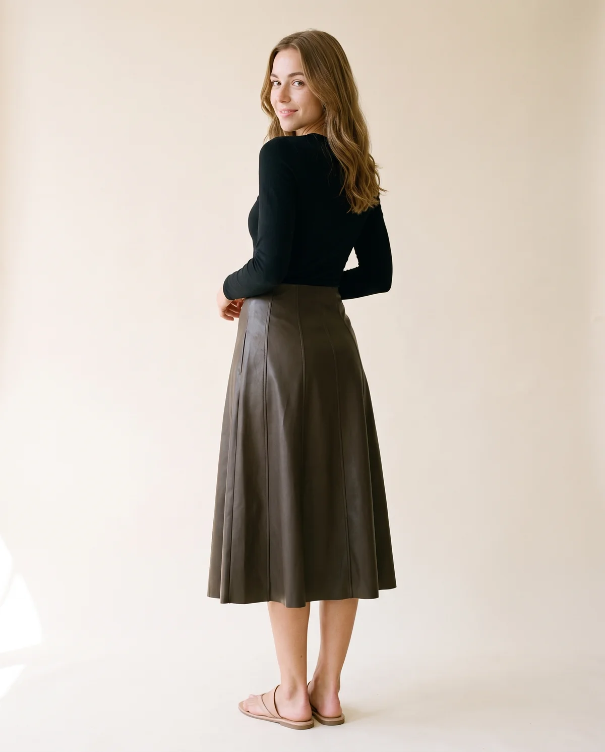 Faux Leather Panelled A-Line Midi Skirt in Dark Olive Brown, back view, worn by Ava