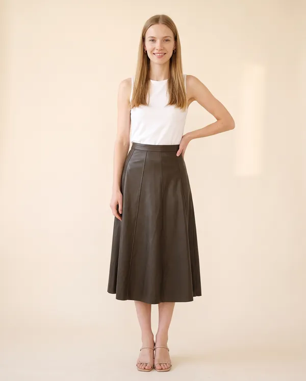 Faux Leather Panelled A-Line Midi Skirt in Dark Olive Brown, front view, worn by Maya