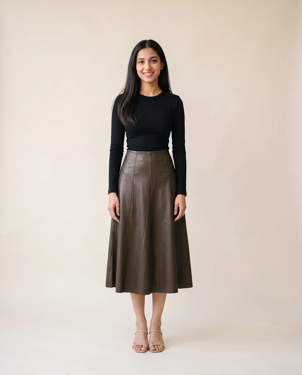 Faux Leather Panelled A-Line Midi Skirt in Dark Olive Brown, front view, worn by Priya