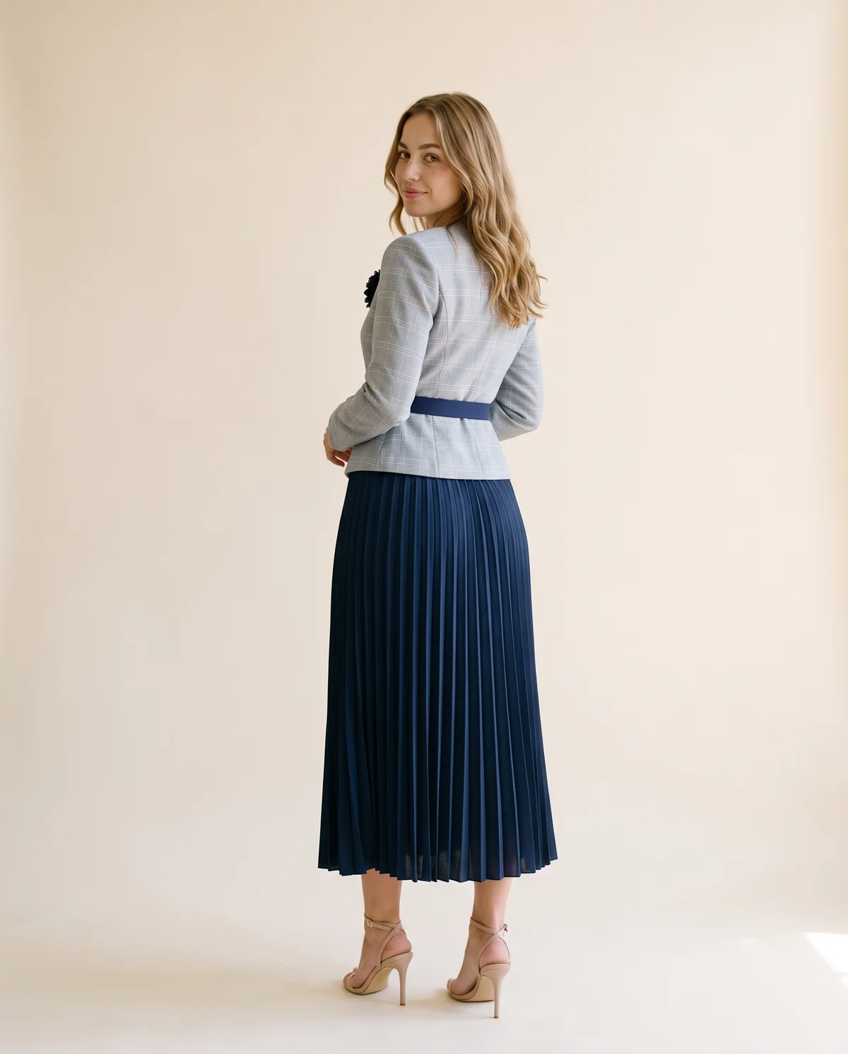 Peplum Blazer and Pleated Midi Skirt Set in Grey Check and Navy, back view, worn by Ava