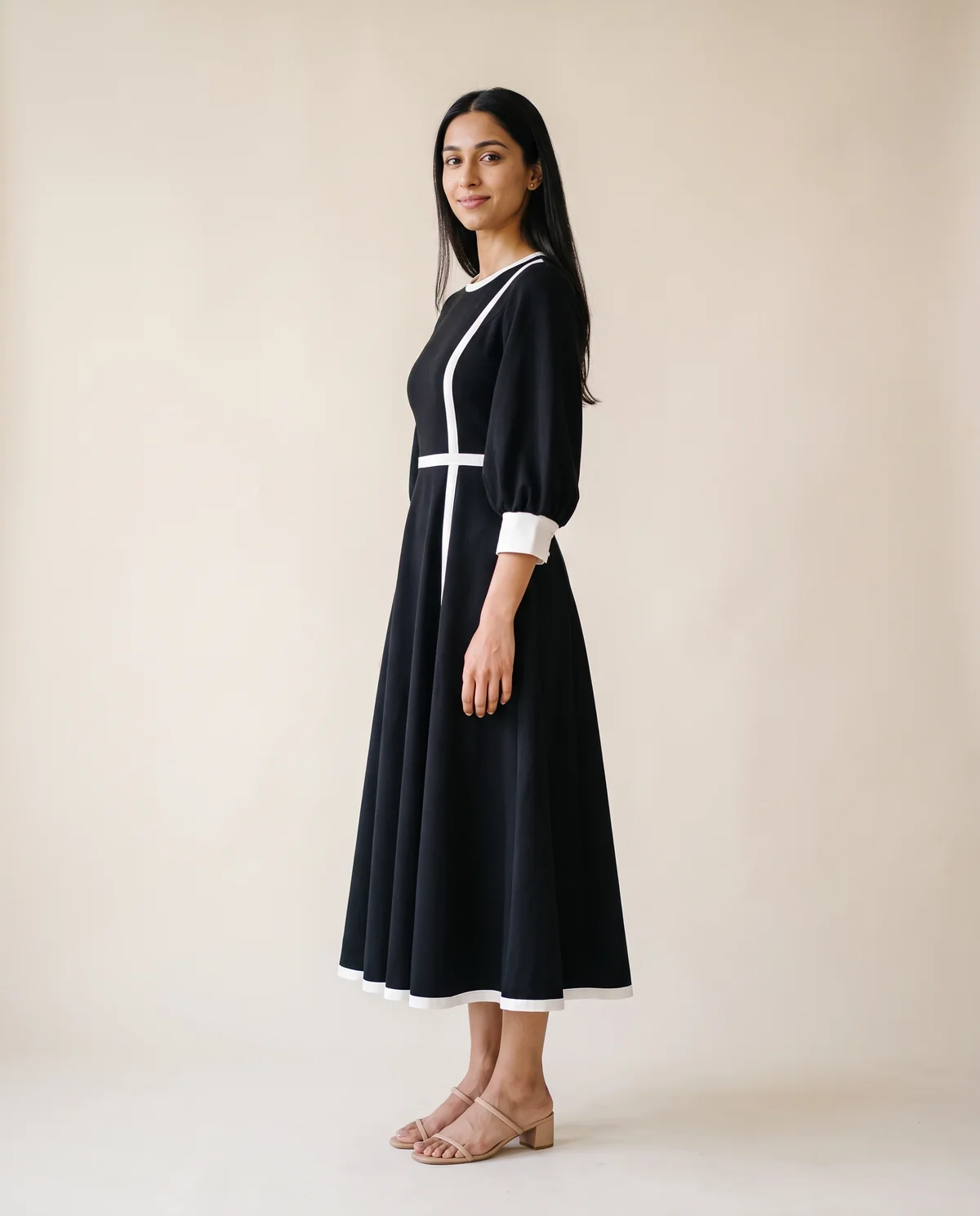 Contrast-Trim Fit-and-Flare Midi Dress in Black, side view, worn by Priya