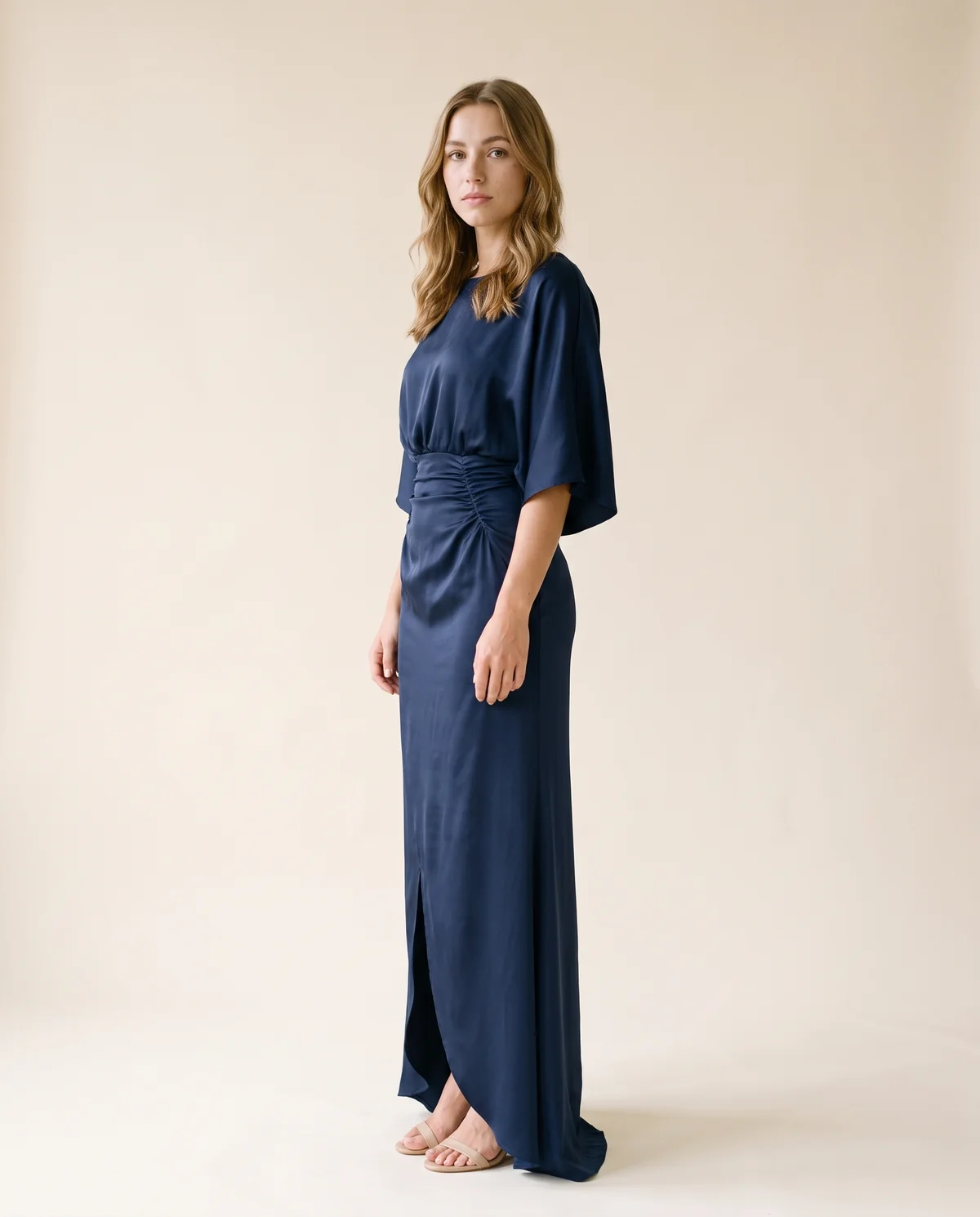 Satin Batwing-Sleeve Maxi Dress with Slit in Navy, side view, worn by Ava