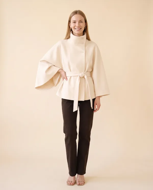 Cape-Sleeve Trench Jacket in Cream, front view, worn by Maya