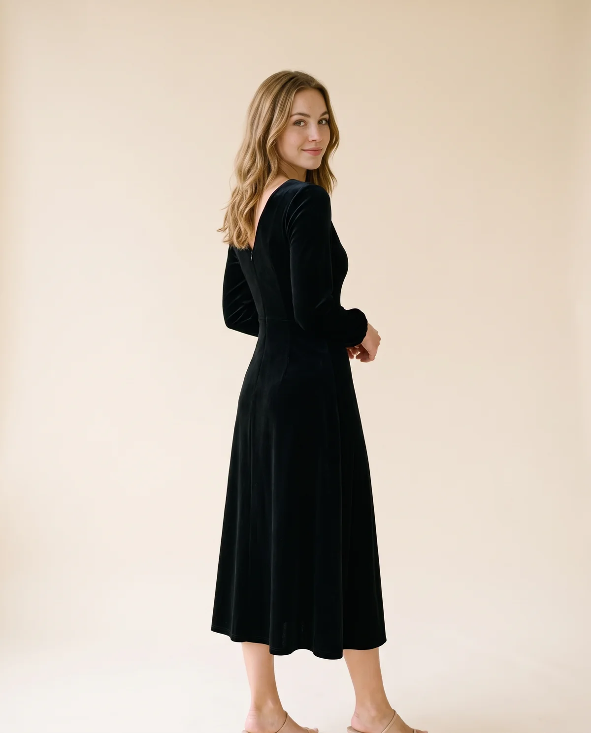 Velvet V-Neck Little Black Midi Dress in Black, back view, worn by Ava