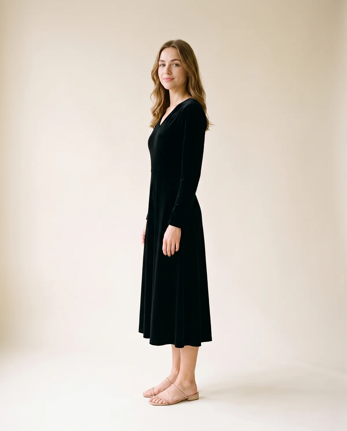 Velvet V-Neck Little Black Midi Dress in Black, side view, worn by Ava