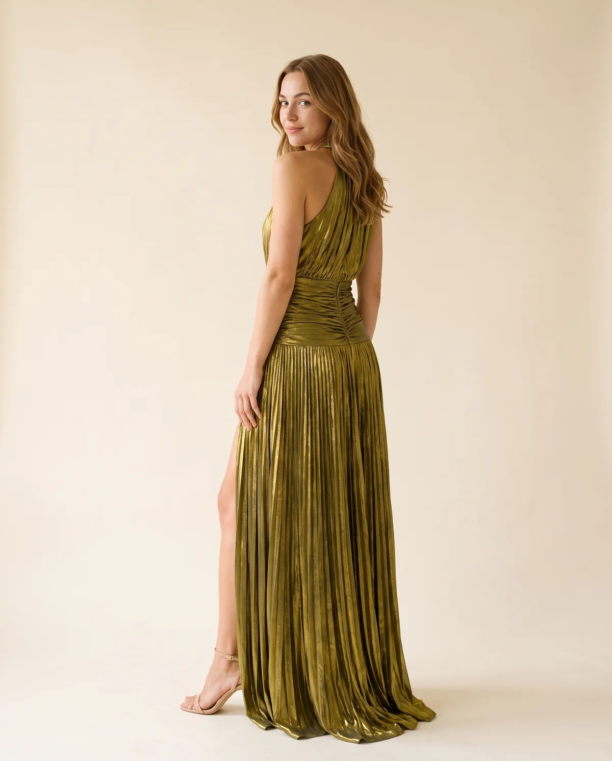 Metallic Pleated Halter Maxi Dress in Olive Gold, back view, worn by Ava