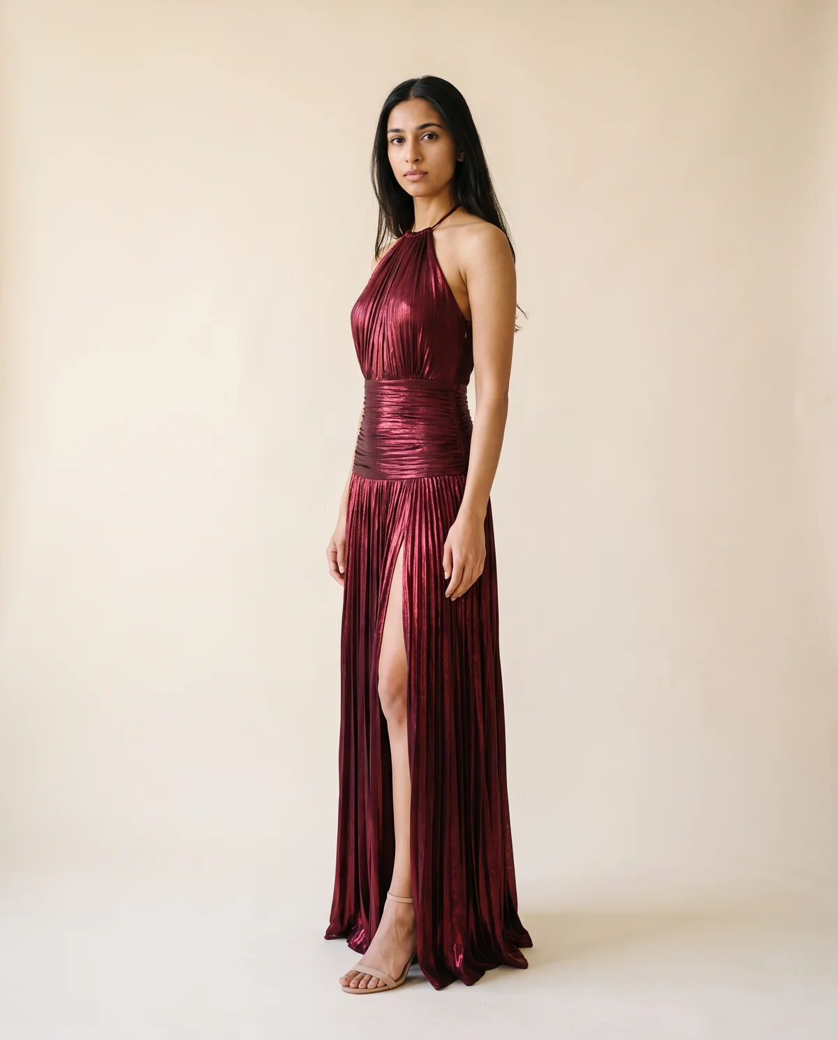 Metallic Pleated Halter Maxi Dress in Wine, side view, worn by Priya