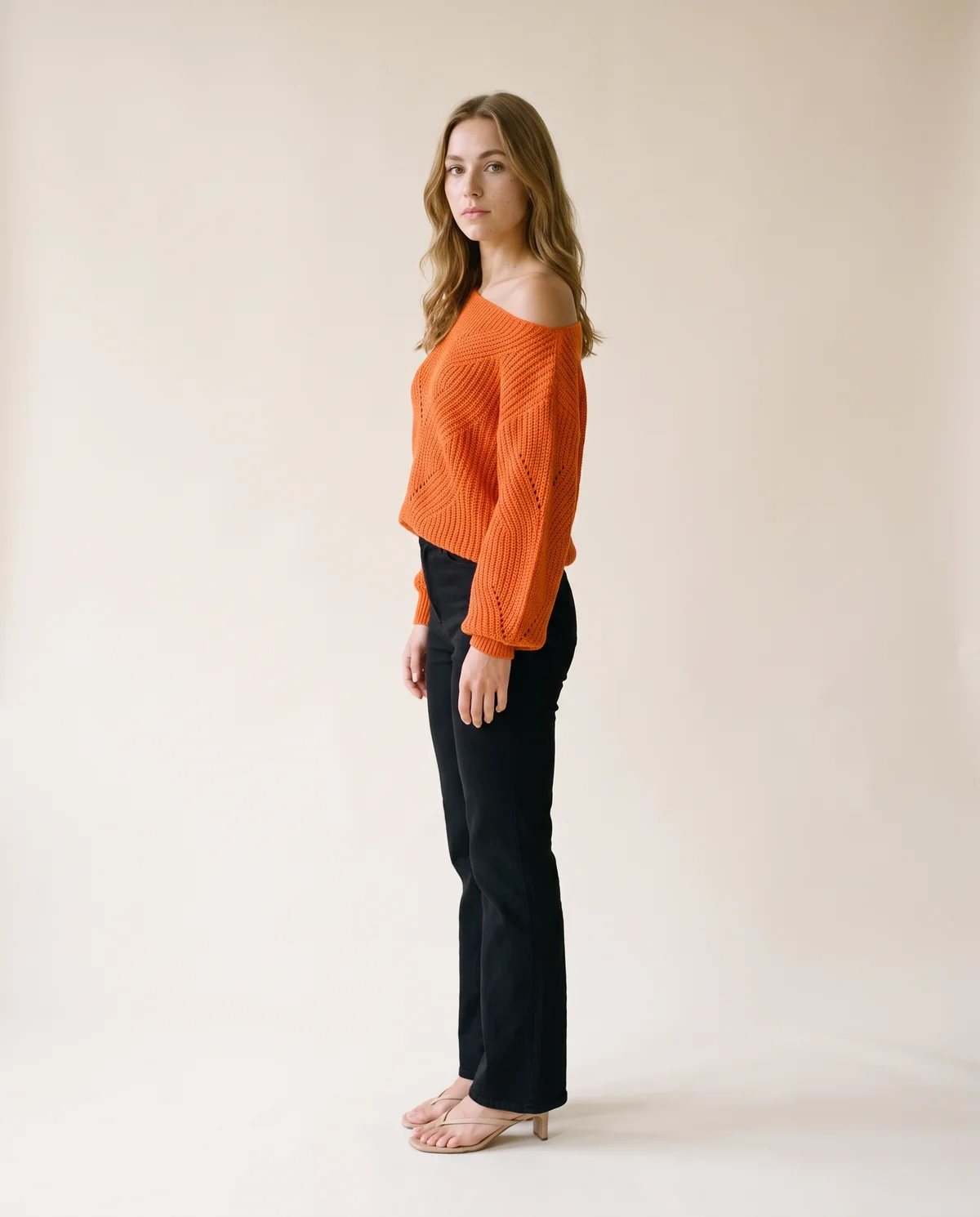 Off-Shoulder Lantern Sleeve Knit Jumper in Orange, side view, worn by Ava