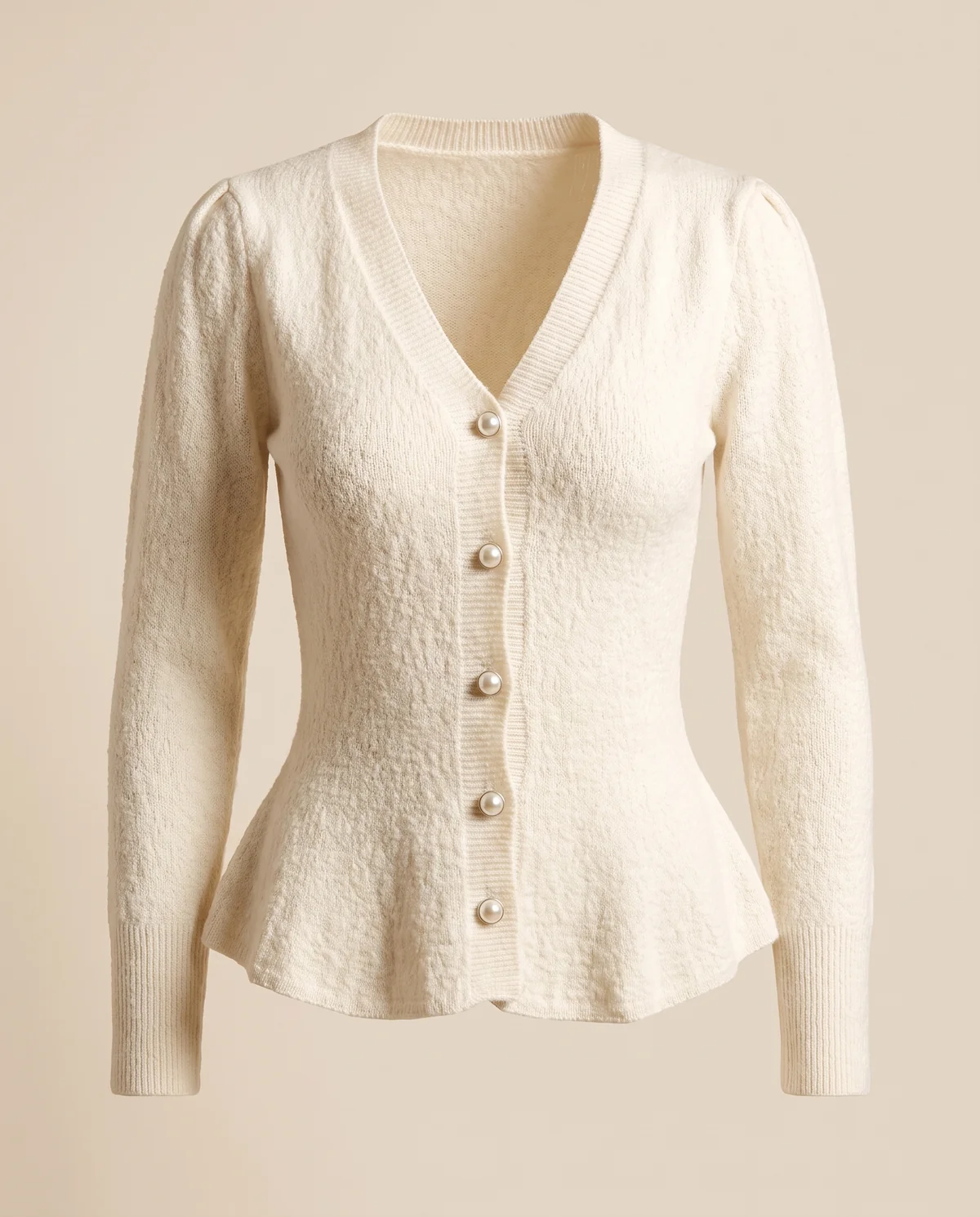Pearl Button Peplum Cardigan in Ivory, product shot on a plain background