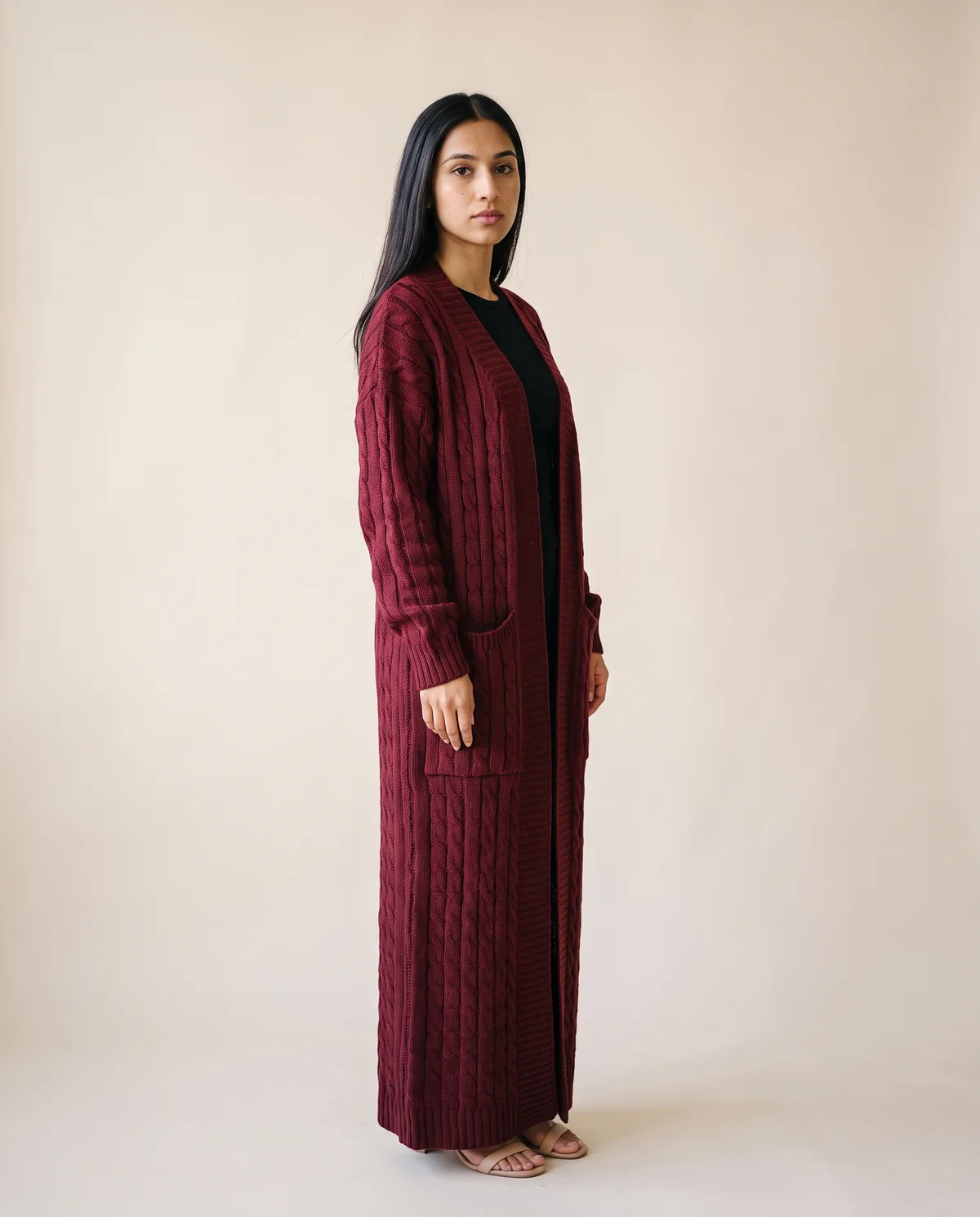 Chunky Cable Maxi Cardigan with Pockets in Burgundy, side view, worn by Priya