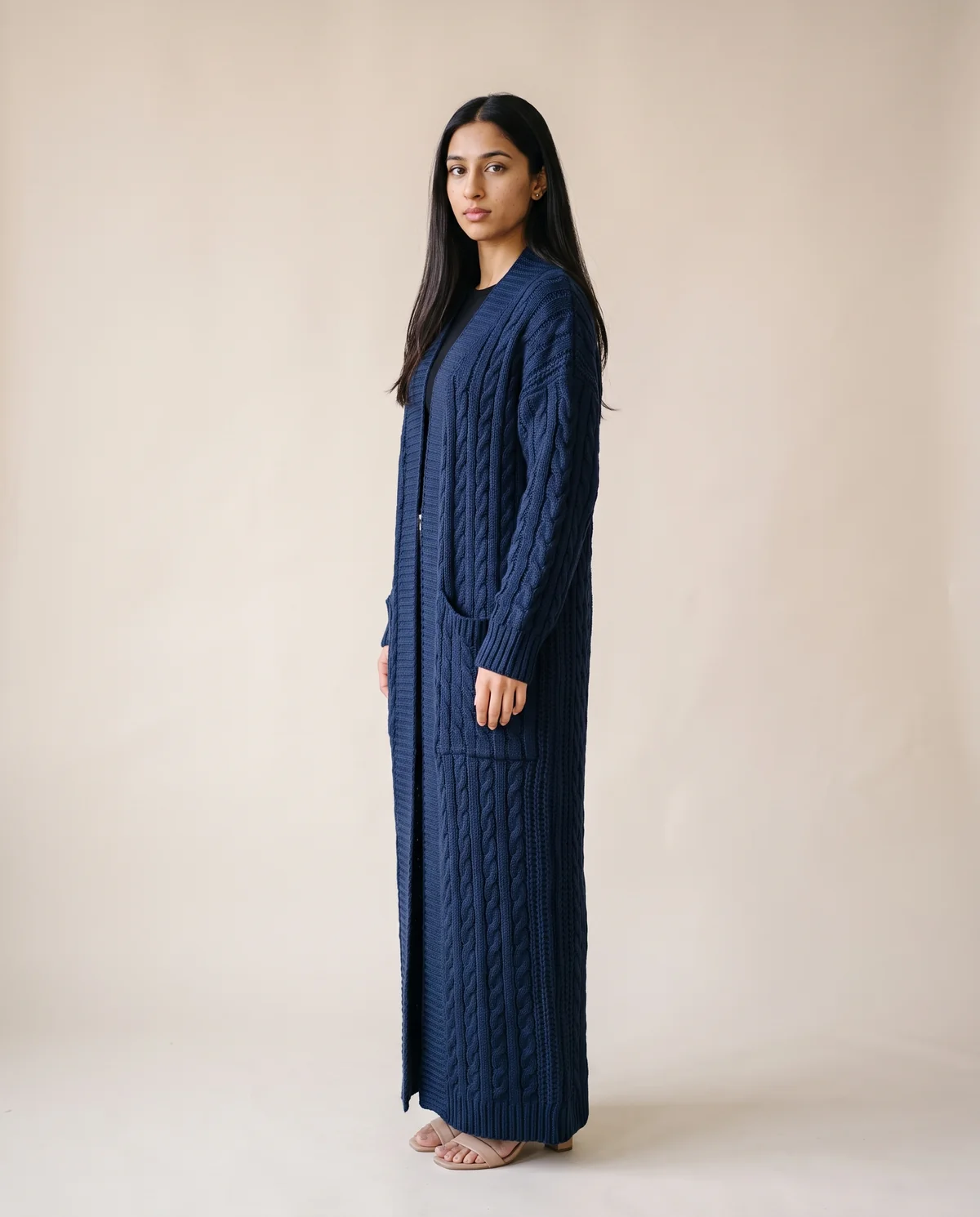 Chunky Cable Maxi Cardigan with Pockets in Navy, side view, worn by Priya