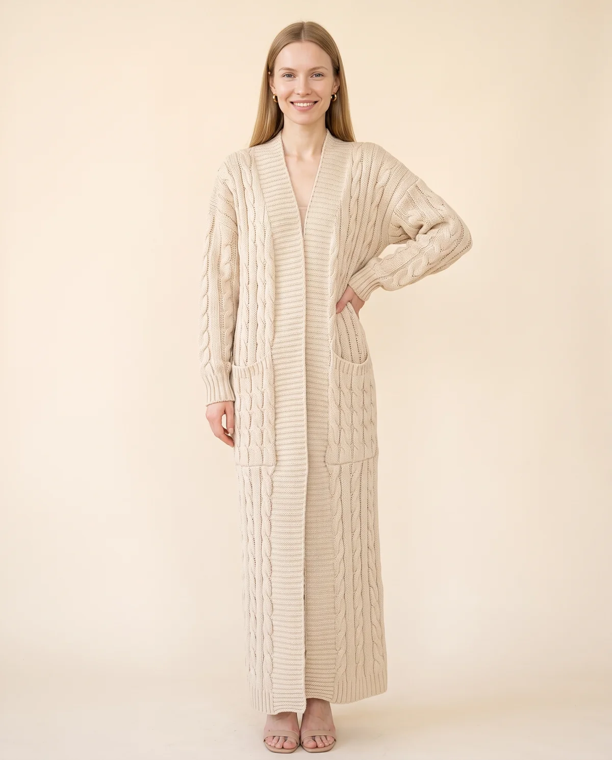 Chunky Cable Maxi Cardigan with Pockets in Beige, front view, worn by Maya