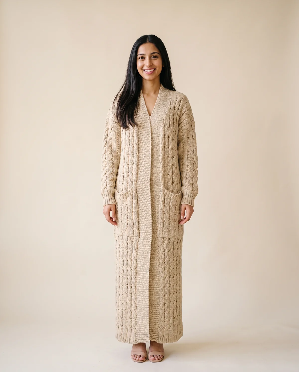 Chunky Cable Maxi Cardigan with Pockets in Beige, front view, worn by Priya