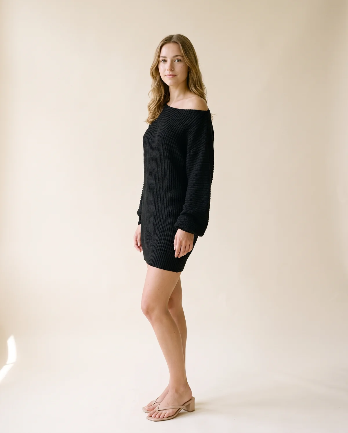 Off-Shoulder Chunky Knit Mini Dress in Black, side view, worn by Ava