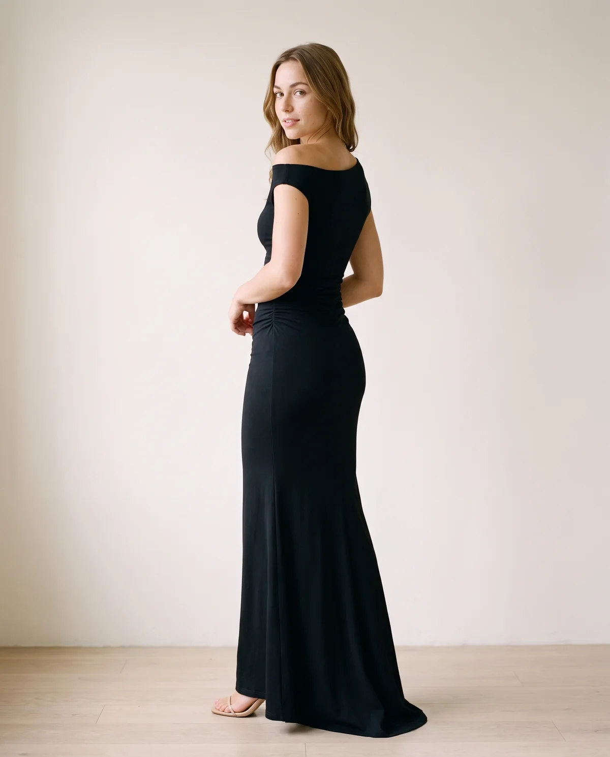 Asymmetric Ruched Jersey Maxi Dress in Black, back view, worn by Ava