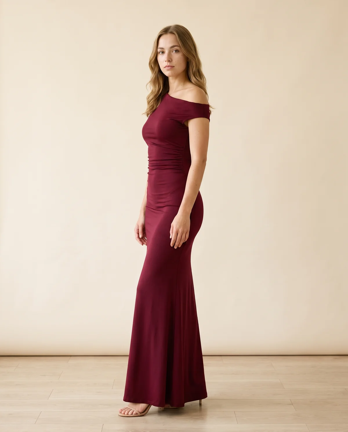 Asymmetric Ruched Jersey Maxi Dress in Wine, side view, worn by Ava