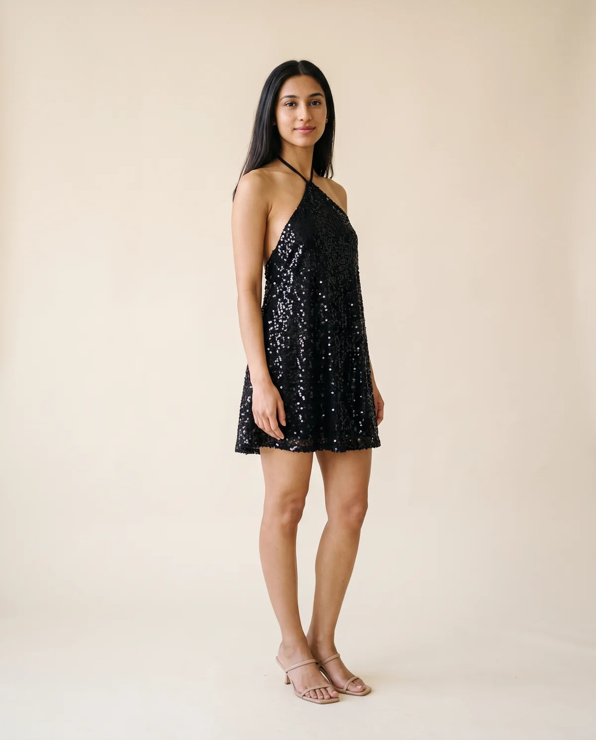 Sequin Halter Swing Mini Dress in Black, side view, worn by Priya