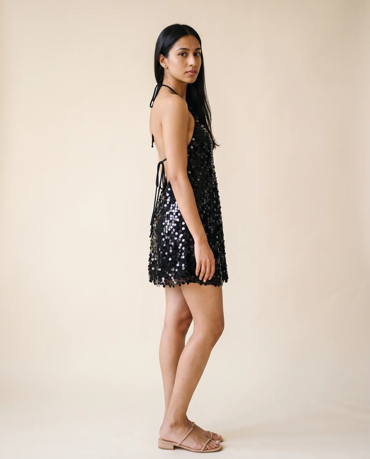 Paillette Halter Backless Mini Dress in Black, side view, worn by Priya