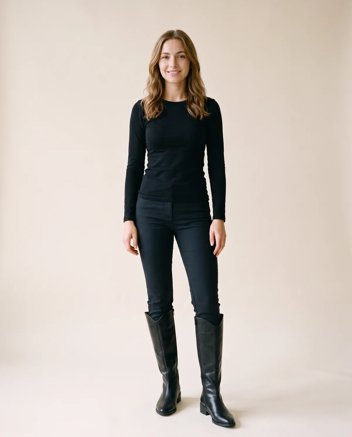 Pointed Low-Heel Knee-High Boot in Black, front view, worn by Ava