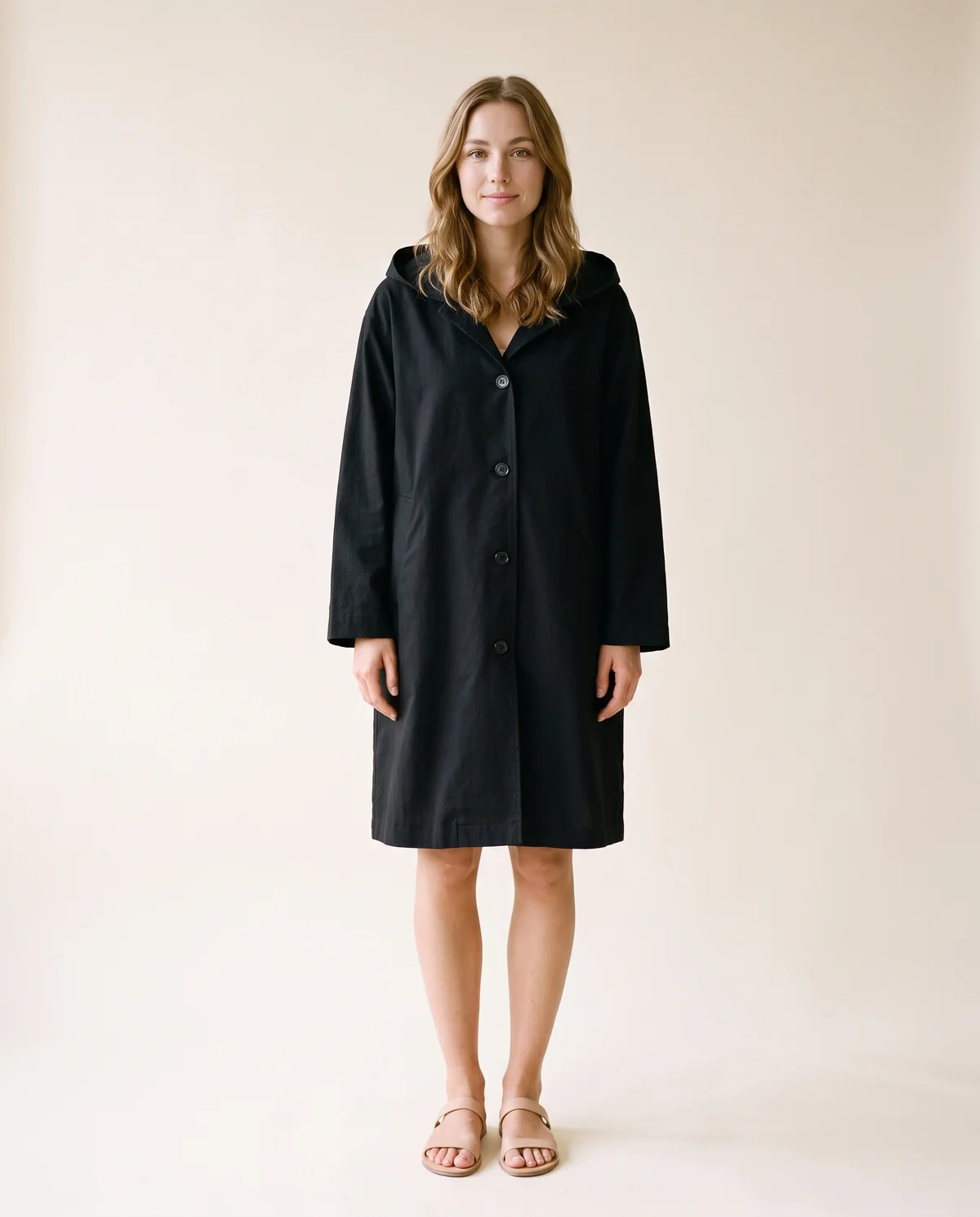 Hooded Trench Coat in Black, front view, worn by Ava