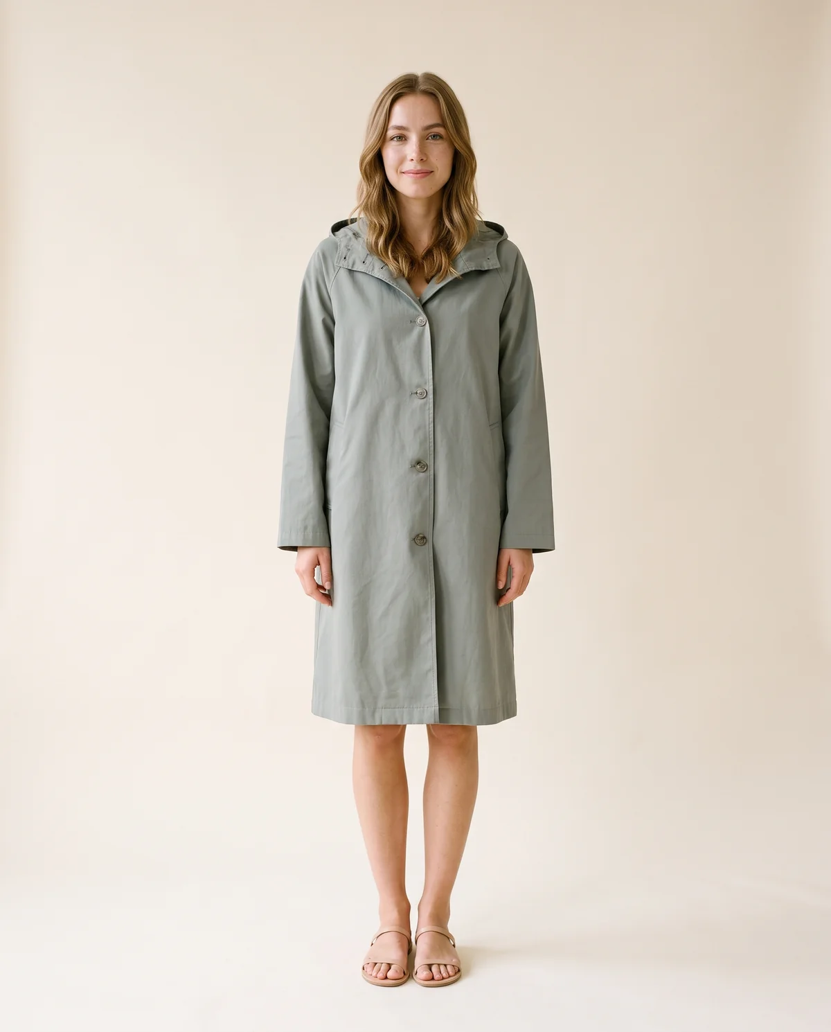 Hooded Trench Coat in Sage Grey, front view, worn by Ava