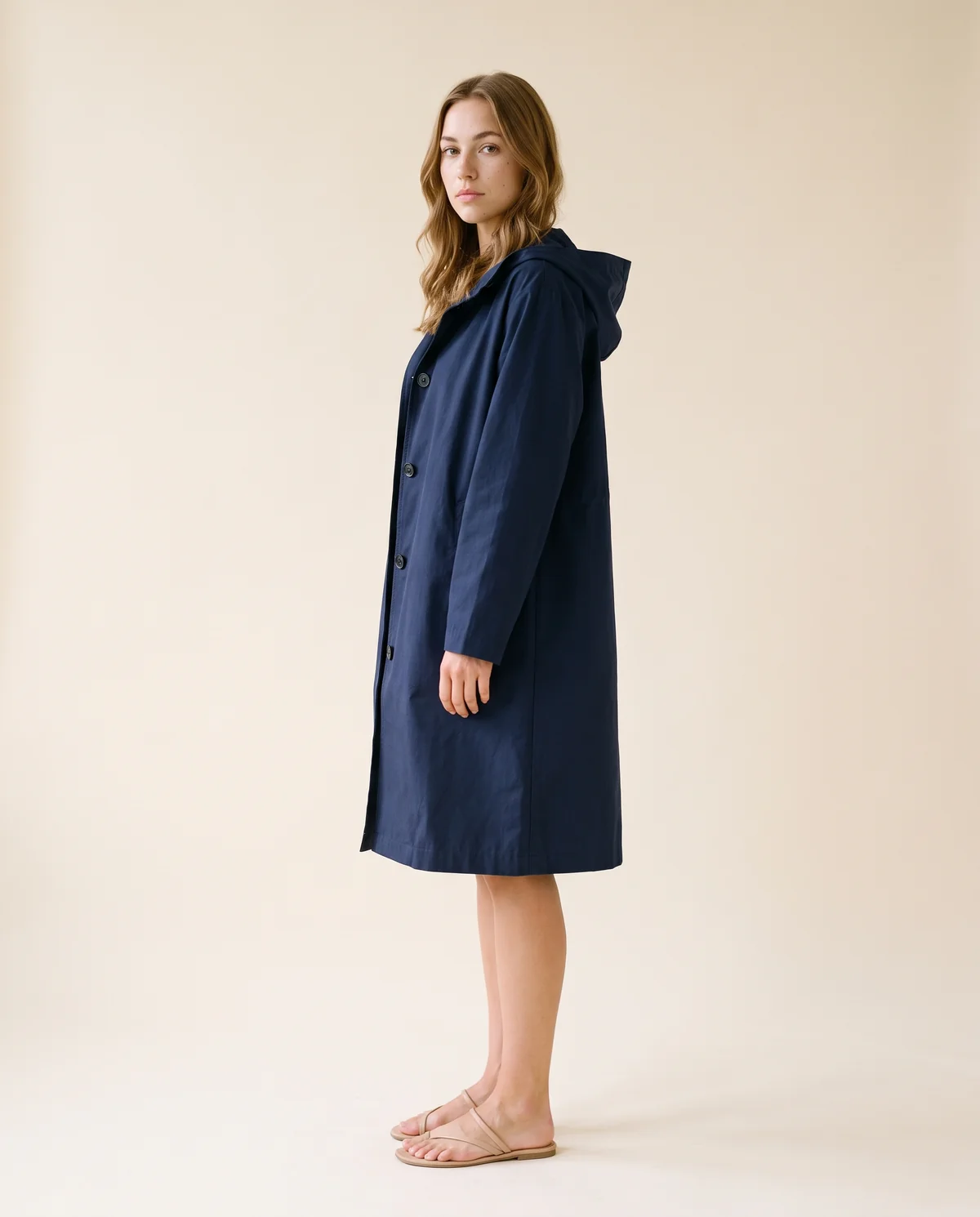 Hooded Trench Coat in Navy, side view, worn by Ava
