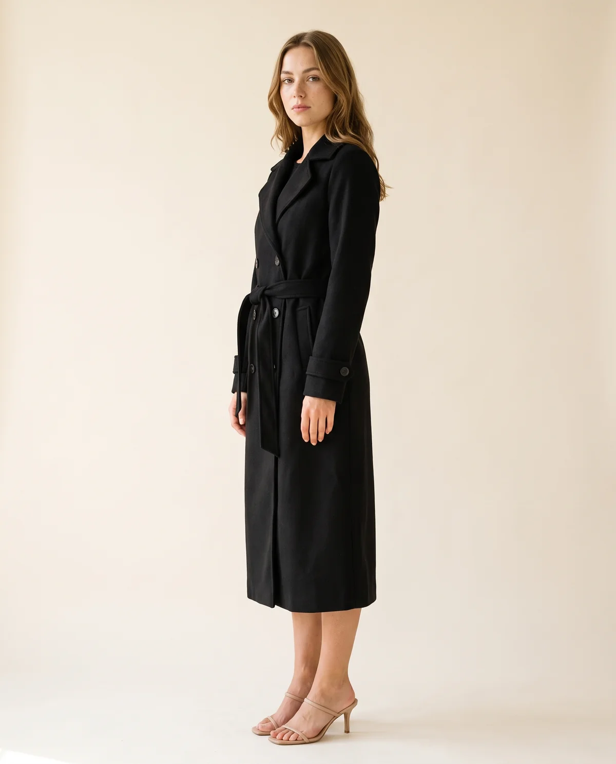 Long Belted Double-Breasted Trench in Black, side view, worn by Ava