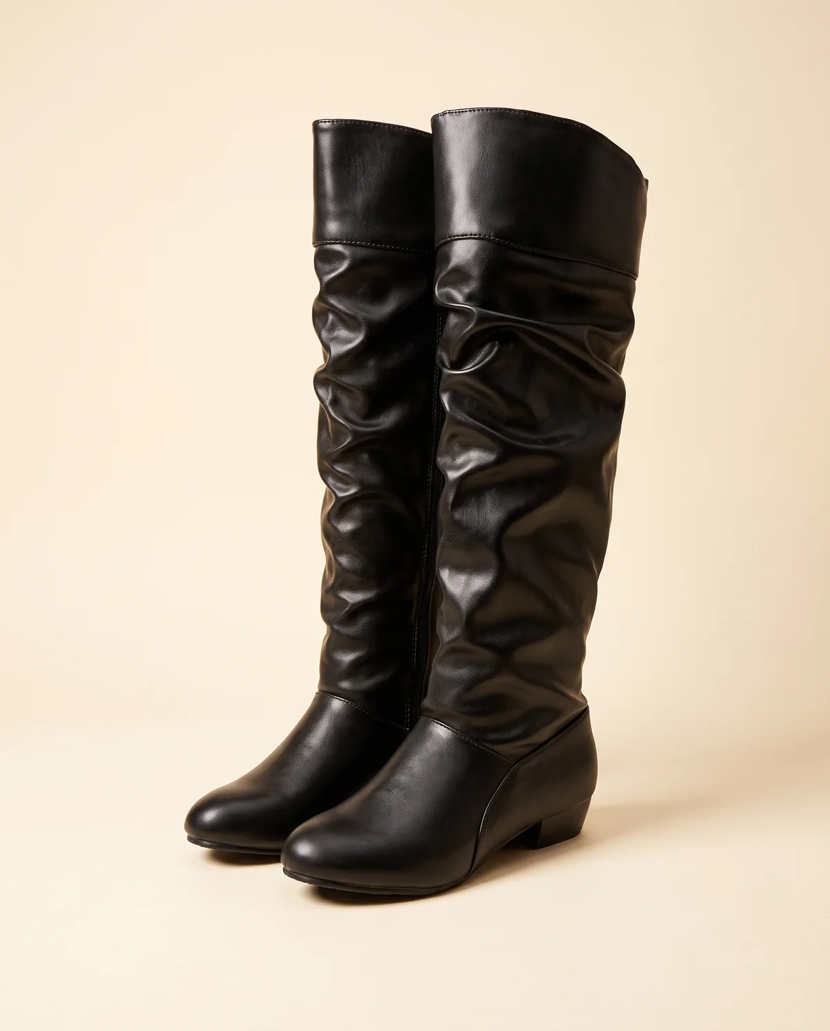 Ruched Slouch Knee-High Boot in Black, product shot on a plain background
