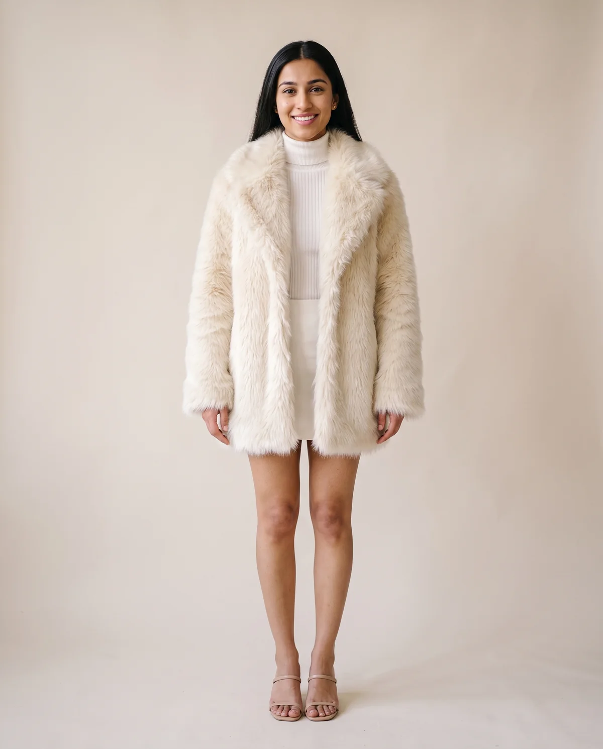 Faux Fur Coat with Wide Collar and Long Pile in Cream, front view, worn by Priya